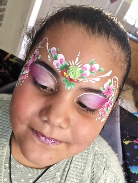 Girl with pink flower face paint in Telford